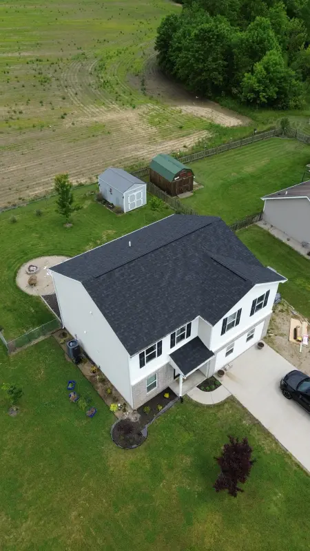 New black architectural shingle roof on a two-story home, seen from above