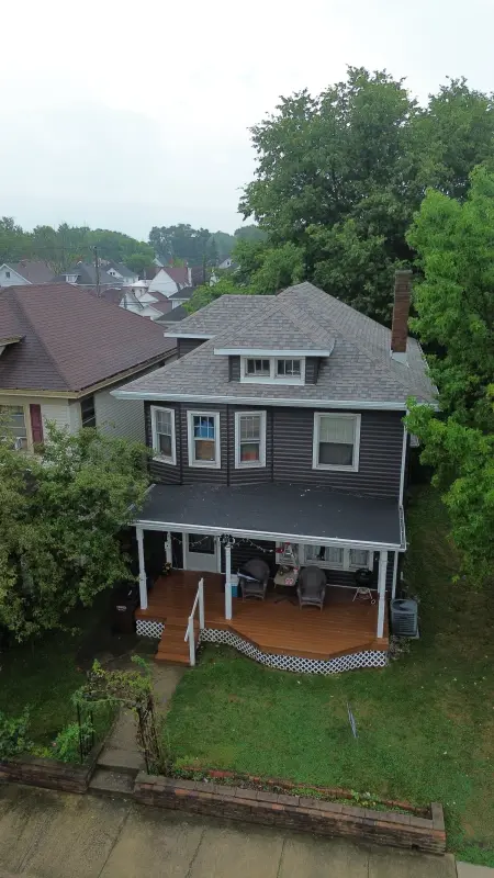 Gray architectural shingle roof on a two-story home with a covered front porch