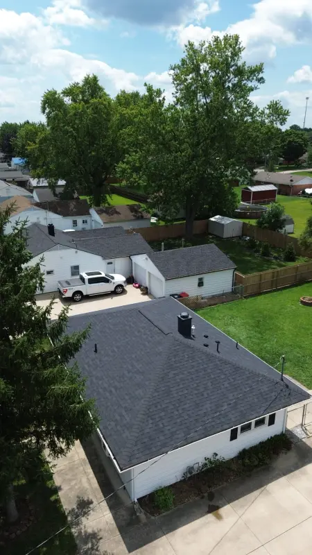 New black shingle roof on a single-story white home