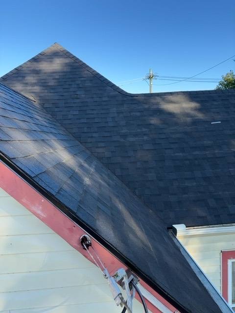 Pitched roof slope with flat section beside it during replacement in Piqua