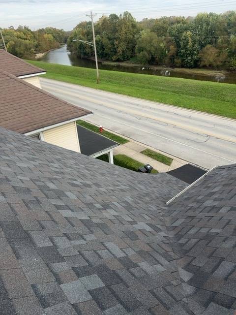 Roof valley and flat sections with new architectural shingles meeting at transitions in Piqua