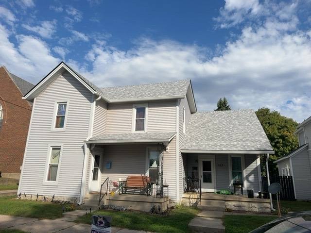 Completed roof with new Sierra Grey shingles on front and side slopes of two-story home in Piqua